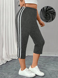 Leggings corti, attillati, elasticizzati e snellenti a righe, per donna taglie forti